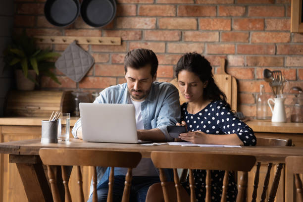 istock Caucasian couple manage family budget on computer together 1300355159