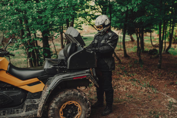 istock Man preparing his quad for extreme ride in forest 1300355390