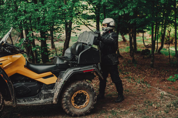 istock Man preparing his quad for extreme ride in forest 1300355392