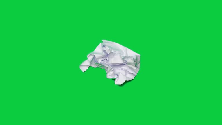 Stop motion animation paper wrinkles making a paper ball. Mint green background