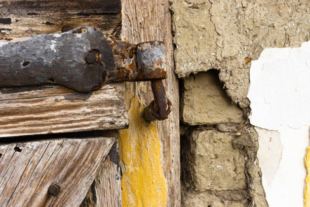 istock Rusty hinge with wooden door 1300356598