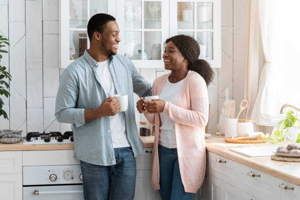istock Black Millennial Couple Spending Time In Kitchen Together, Drinking Coffee And Chatting 1300356600