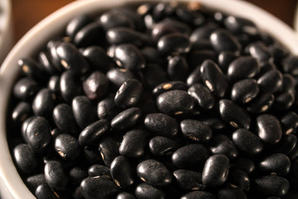 istock black beans on wood background 1300356629