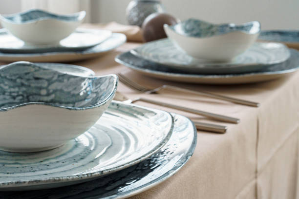 istock Details of a stylish table setting with textured ceramic dishes 1300358453