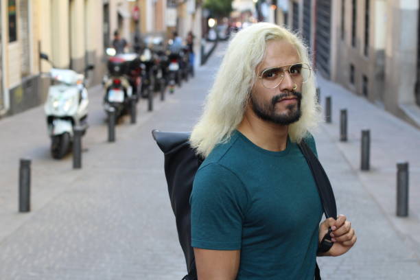 istock Man with long blonde dyed hair 1300358518