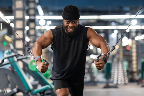 istock Motivated black sportsman having workout on crossover machine 1300358536