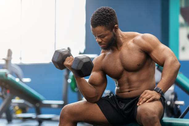 istock Handsome african american muscular man exercising with barbell 1300359388