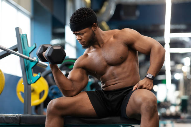 istock Concentrated african american muscular guy exercising with barbell 1300359428