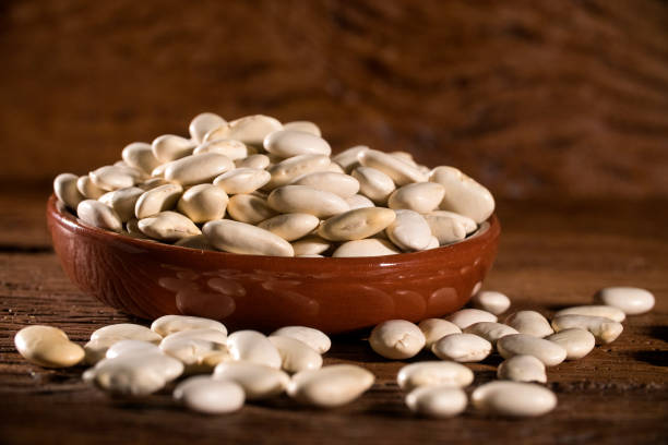 istock White beans on wood background 1300360606