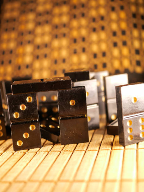 istock Black vintage dominoes on a black background, selective focus. WB photo. 1300361102