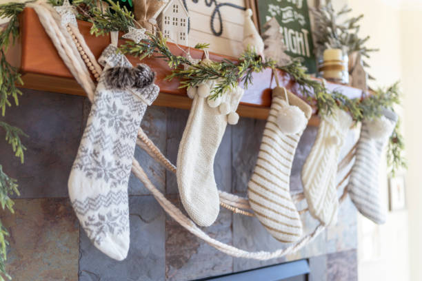 istock Fireplace mantel with white Christmas stockings decorated for winter 1300362321