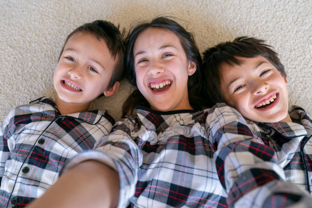 istock Siblings taking selfie photo on Christmas morning 1300362353