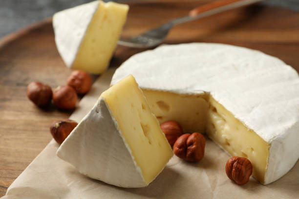 istock Board with camembert and hazelnut, close up 1300362508