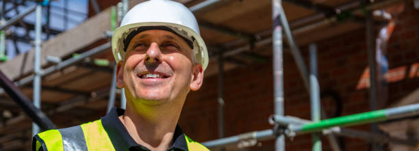 istock Panoramic web banner of male builder foreman, worker, contractor or architect on construction site panorama 1300362548