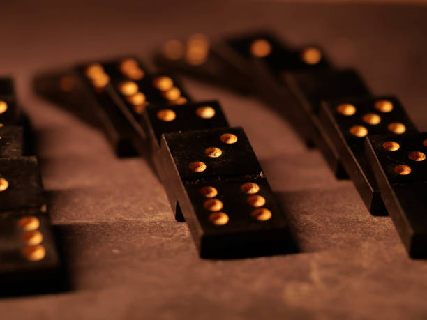 istock Black vintage dominoes on a black background, selective focus. WB photo. 1300362777
