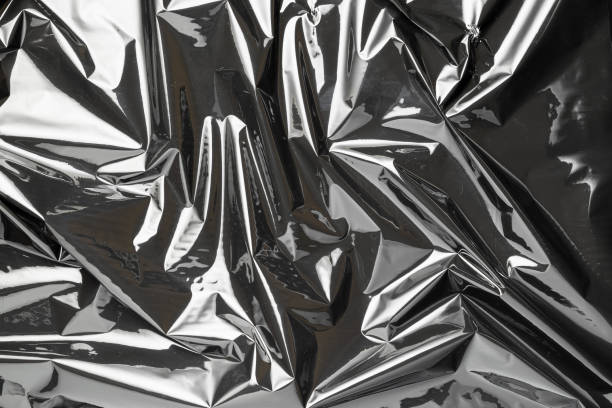 istock Plastic wrap. Black shiny film bag pattern. Transparent dark cellophane texture. Creative crumpled background. 1300363461