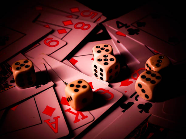 istock Dice and playing cards, black background 1300363571