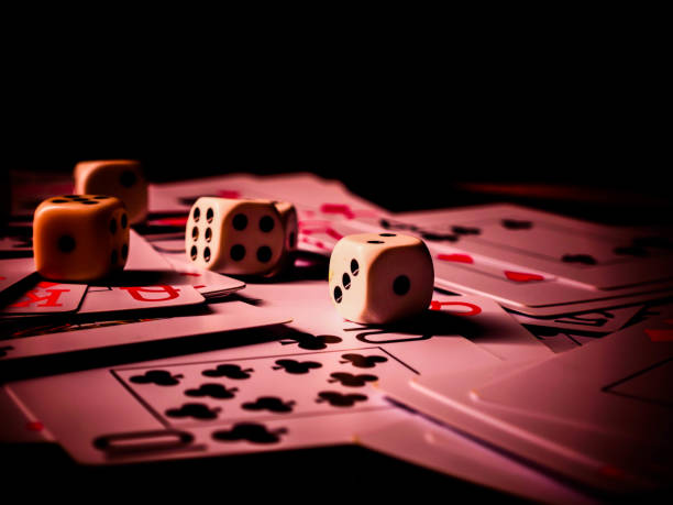 istock Dice and playing cards, black background 1300363588