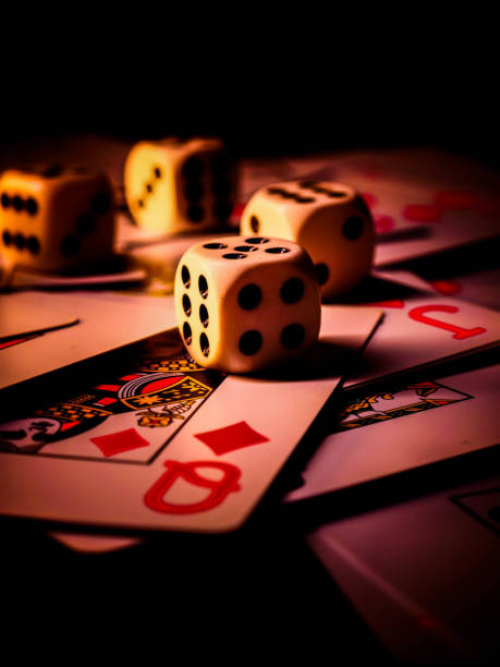 istock Dice and playing cards, black background 1300363612