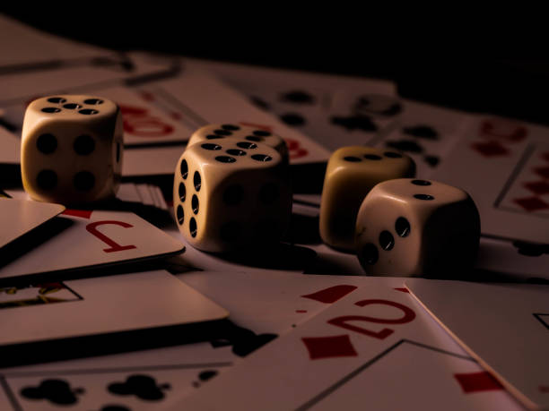istock Dice and playing cards, black background 1300363624