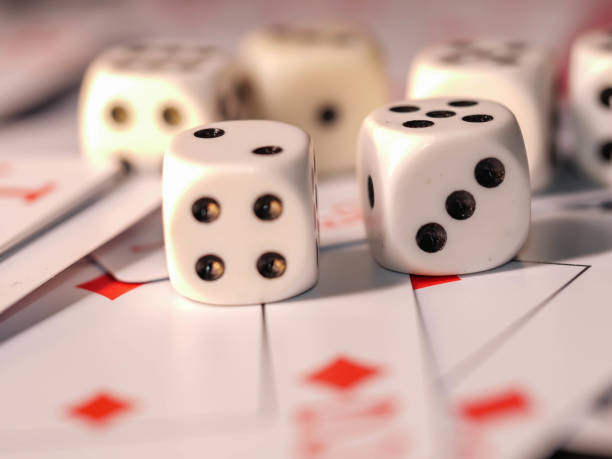 istock Dice and playing cards, black background 1300363717