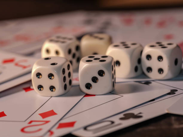 istock Dice and playing cards, black background 1300363726