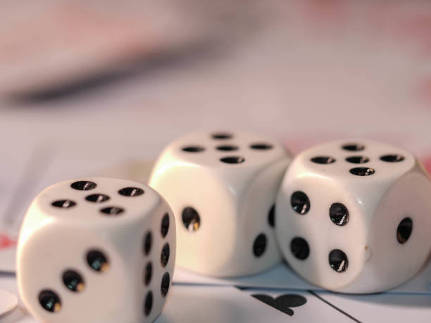 istock Dice and playing cards, black background 1300363730