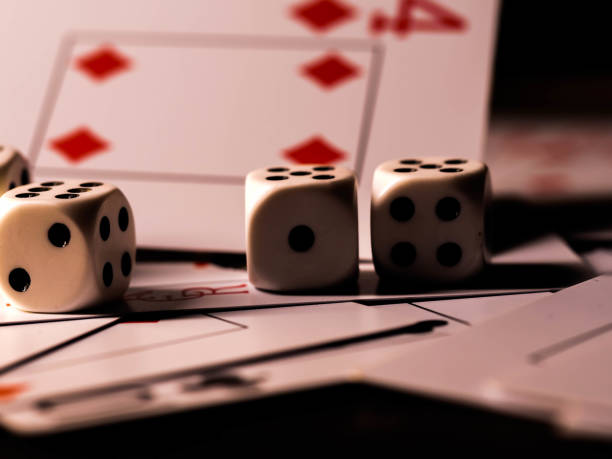 istock Dice and playing cards, black background 1300363738