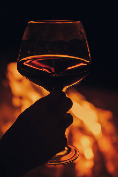 istock Wine glass with bonfire in background. 1300363850