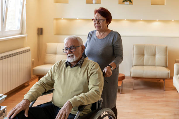 istock Senior Woman is Helping her Disabled Husband. 1300365796