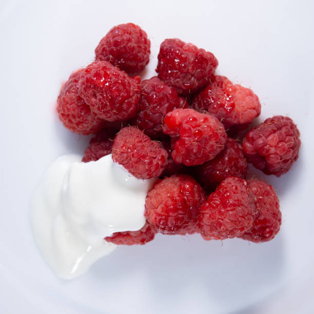 istock Red raspberries poured with sour cream 1300369655