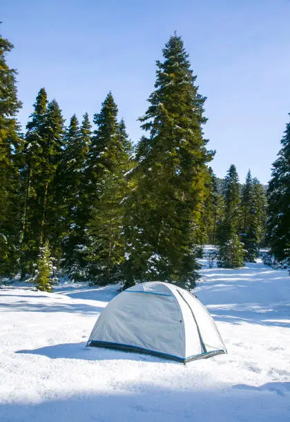 White camping tent on snowy ground