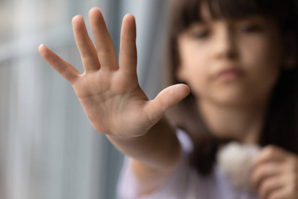 istock Close up lonely little girl offering hand, asking help 1300371830
