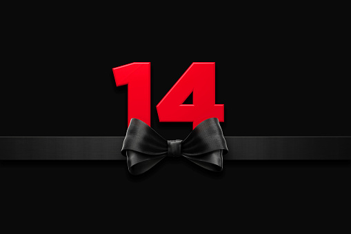 Valentine's Day, love, courtship, dating, engagement, relationships concept. Red number 14 sitting behind black ribbon over black background. Horizontal composition with copy space. Copy space available