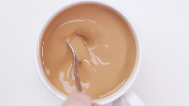 Man stirring coffee in slow motion