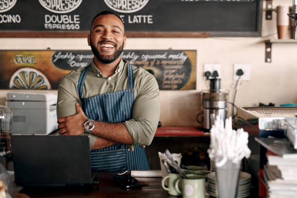 Business has been growing and I couldn't be happier Portrait of a young man working in a cafe franchising photos stock pictures, royalty-free photos & images