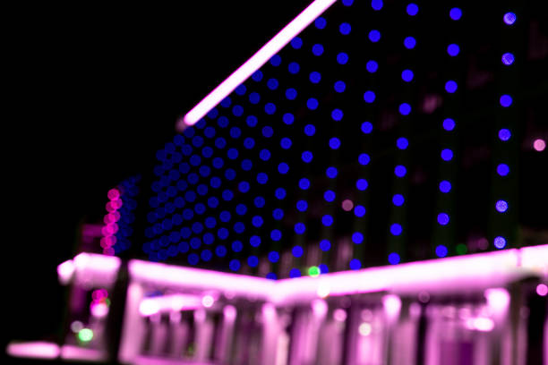 istock Blurred office building with illuminated facade exterior at night. Blurry modern business building  with bokeh light and defocused dots. Blur windows office building for background 1300376072