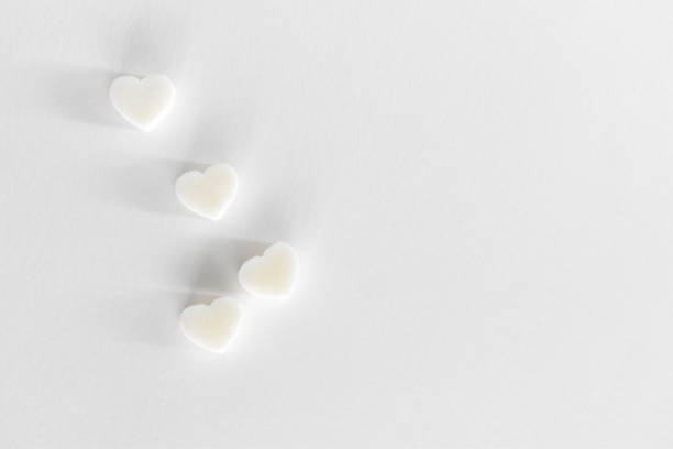 istock Tender White background for Valentine's day. Minimal layout with hearts and copy space. Flat lay. 1300377344