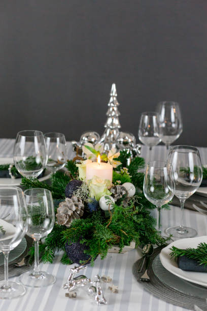istock Stylish table decoration in gray with a pine branch 1300378436