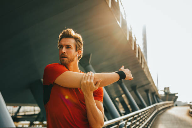 istock A man stands on the path and stretches his arms 1300378439
