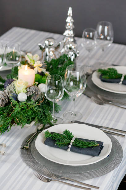 istock Stylish table decoration in gray with a pine branch 1300378559