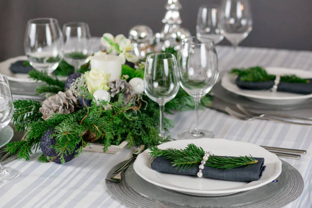 istock Stylish table decoration in gray with a pine branch 1300378690