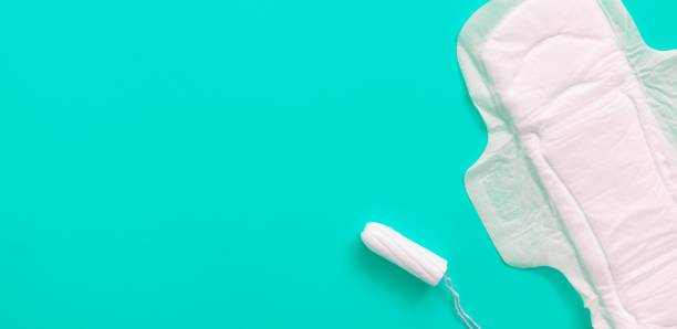 istock Tampon and sanitary pad on blue background with copy space 1300380656