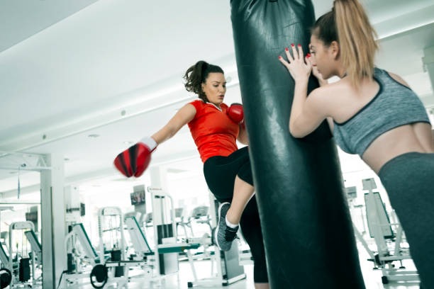 istock Woman practicing boxing in gym ,knee kicking 1300383491
