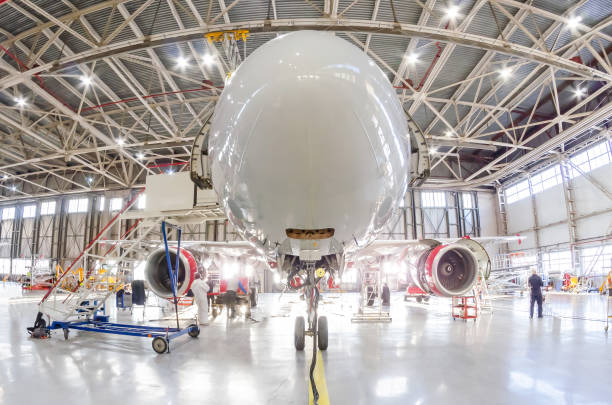 Aircraft in the under the hangar roof aviation industrial on maintenance, outside the gate bright light. Aircraft in the under the hangar roof aviation industrial on maintenance, outside the gate bright light airplane crash photos stock pictures, royalty-free photos & images