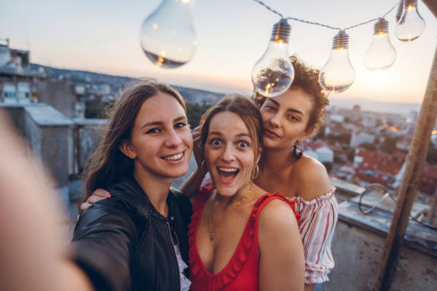 istock Three young women making selfie on rooftop 1300384829