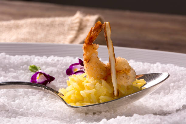 istock Shrimp breaded in tapioca with coconut rice and crispy coal cheese 1300384890