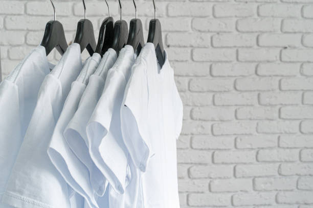 istock White t-shirt hanging on hanger against brick wall 1300386120