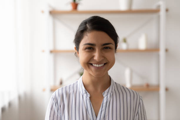 istock Happy young indian lady looking at camera posing at home 1300386290