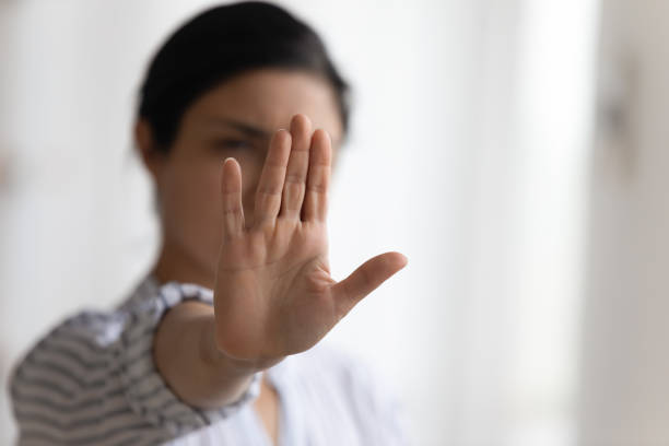 istock Focus on female palm raising up in stop gesture 1300386322